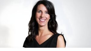 Carey Lohrenz, the first female F-14 Tomcat pilot in the U.S. Navy, standing next to her aircraft.