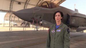 Lt. Col. Christine Mau, first female F-35A fighter pilot, standing in front of her aircraft.