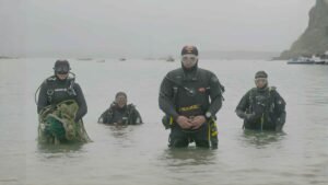 divers inspect ash-covered river
