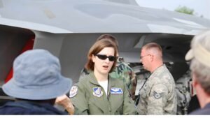 Jammie Jamieson, the first female F-22 Raptor pilot, standing next to the fighter jet.